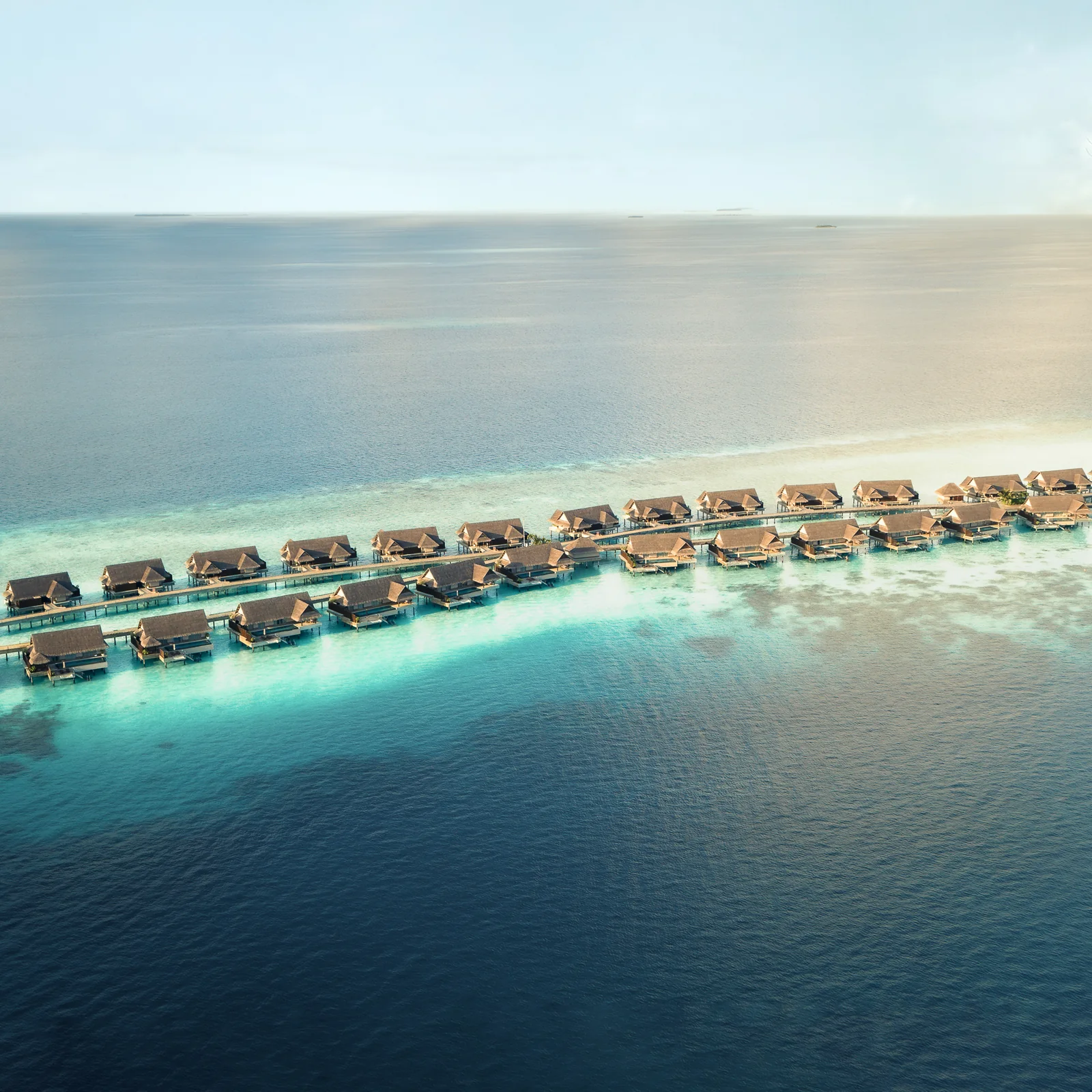 Aerial view of overwater villas at JOALI Maldives in Raa Atoll